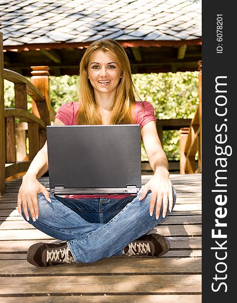 Beautiful young student using laptop outdoor. Beautiful young student using laptop outdoor.