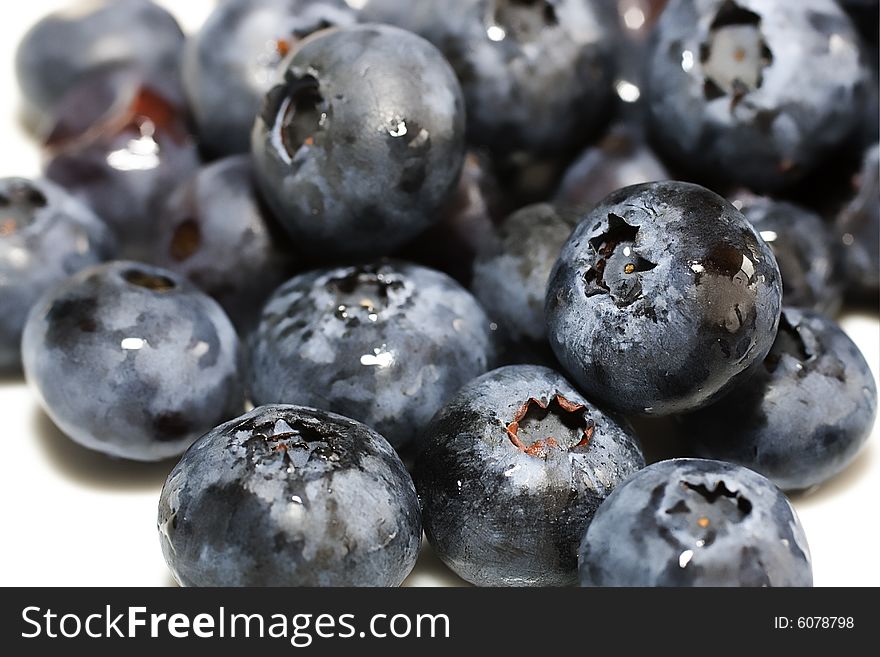 Macro shot of blueberries isolated against white background. Macro shot of blueberries isolated against white background