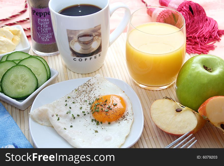 Fresh breakfast with an egg, fruits, bread and vegetables