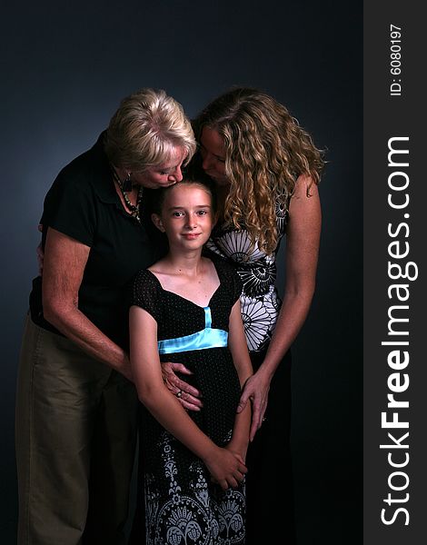 Three generations of women with child being kissed. Three generations of women with child being kissed