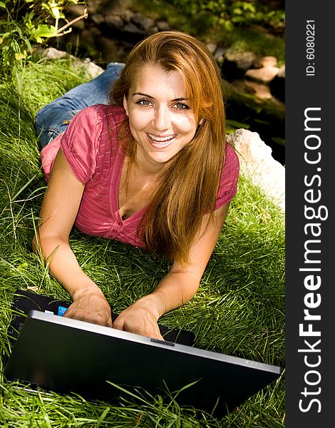 Beautiful young student using laptop in natural environment. Beautiful young student using laptop in natural environment.