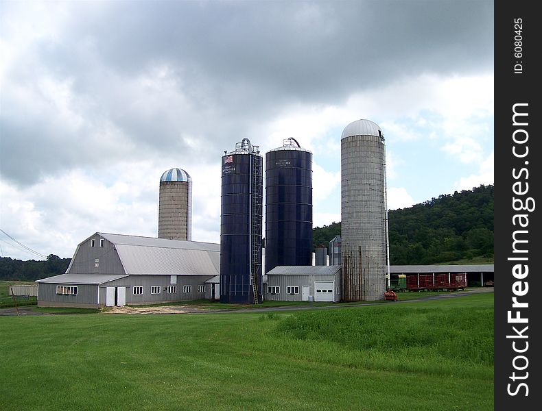 A large sprawling farm sits underneath a perilous sky
filling with black storm clouds. A large sprawling farm sits underneath a perilous sky
filling with black storm clouds.