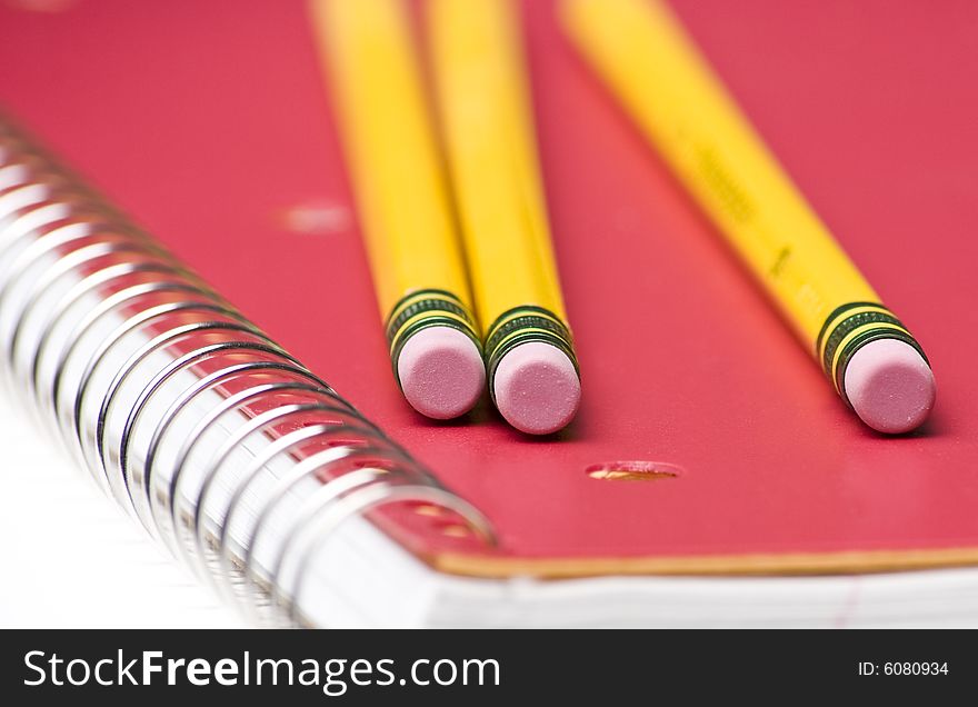 Pencils on red Notebook Close Up. Pencils on red Notebook Close Up