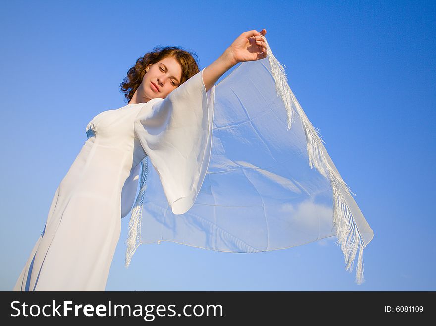 Young woman against a background blue sky. Young woman against a background blue sky