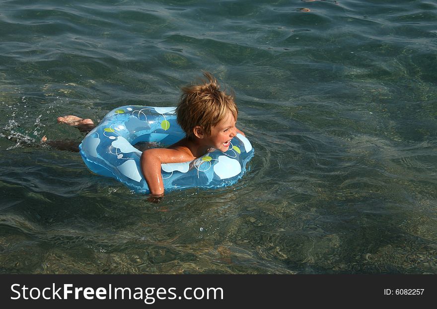 Girl floats on a lifebuoy ring