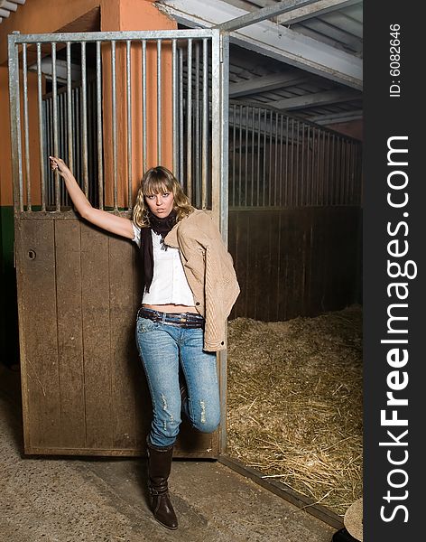 Sexy girl with jeans in an stable