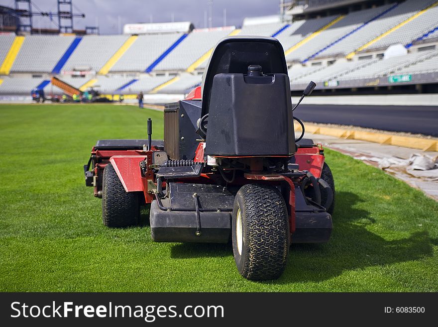 Old lawnmower in a great football field