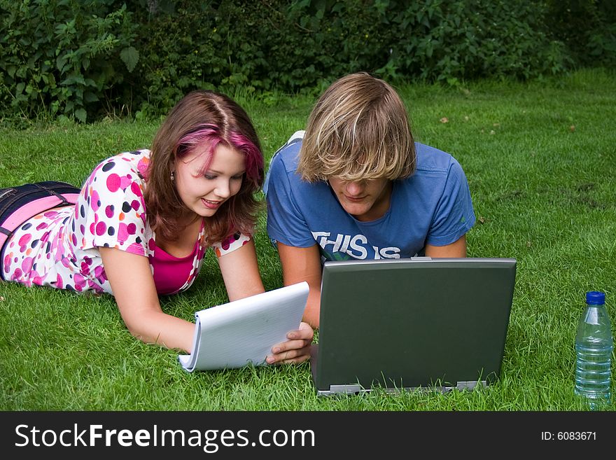 Students studying in a park in the summertime. Students studying in a park in the summertime