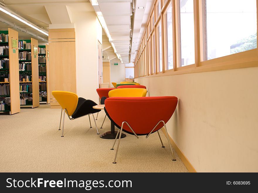 Library reading area with colorful seats in red, green and yellow. Library reading area with colorful seats in red, green and yellow