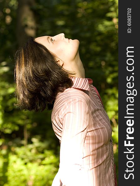 Outdoor portrait of woman looking upwards