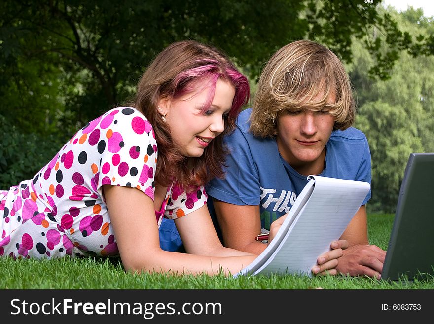 Students studying in a park in the summertime. Students studying in a park in the summertime