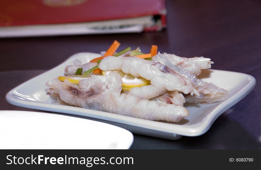 Delicious chinese cuisine - Gold chicken feet with chili in white plate. Delicious chinese cuisine - Gold chicken feet with chili in white plate