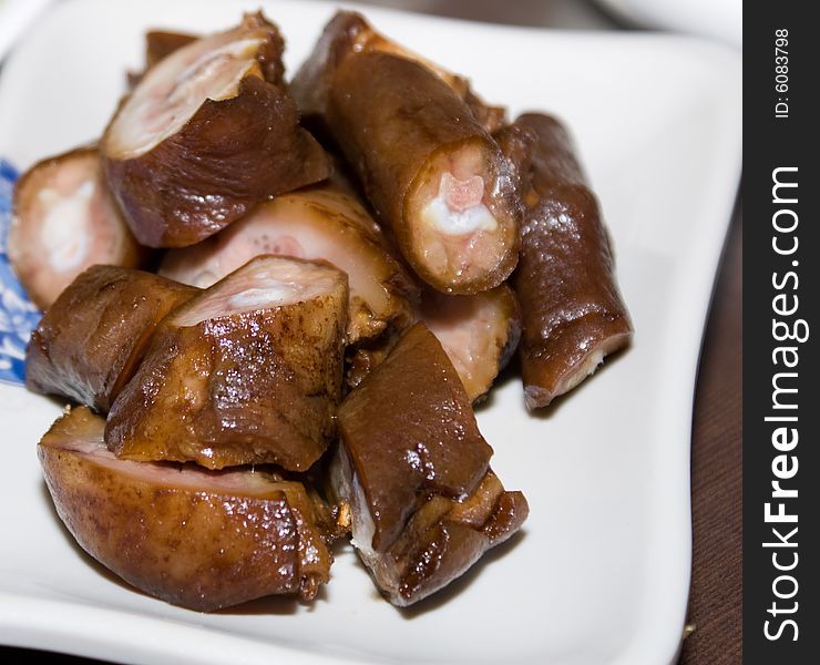 Delicious chinese cuisine - fried pig tail in white plate
