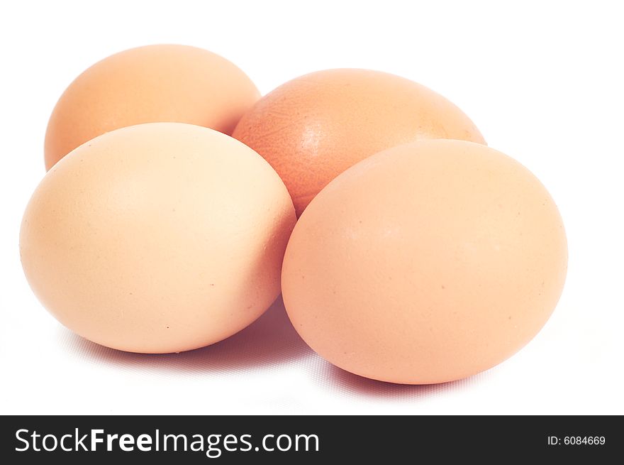 Four eggs.Color of chicken eggs - brown. Isolated on a white background.