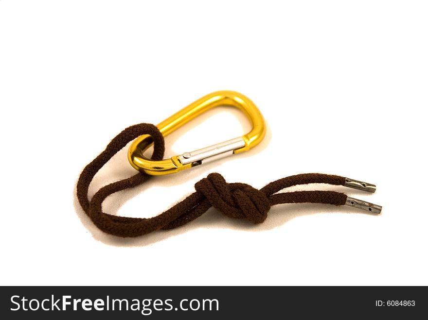 Golden carabine and brown lace isolated on the white background. Golden carabine and brown lace isolated on the white background.