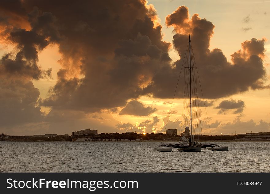 Sail boat anchored in bay at sunset. Sail boat anchored in bay at sunset