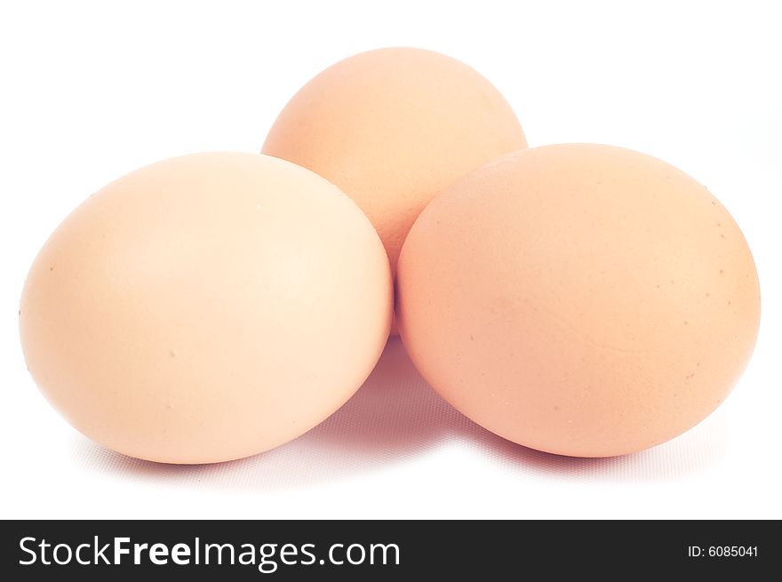 Three eggs.Color of chicken eggs - brown. Isolated on a white background.