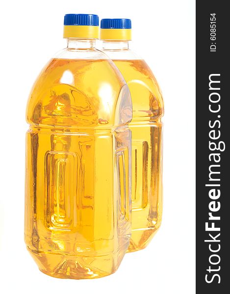 Two bottles filled with sunflower oil. Isolated on a white background. Two bottles filled with sunflower oil. Isolated on a white background.