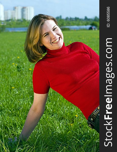 Woman in red jacket on summer's meadow. Woman in red jacket on summer's meadow.