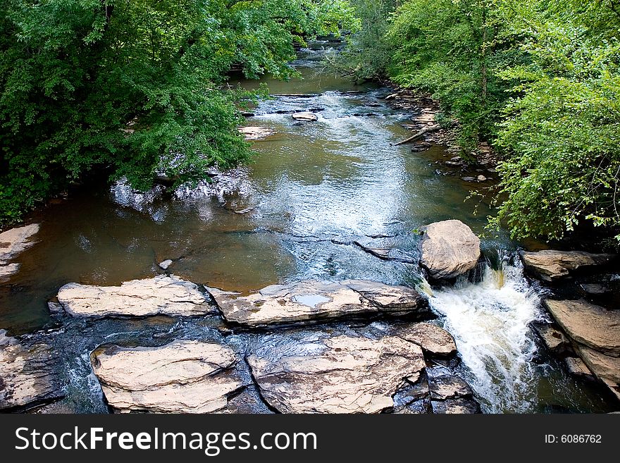 Water flowing over rocks in a rural stream. Water flowing over rocks in a rural stream