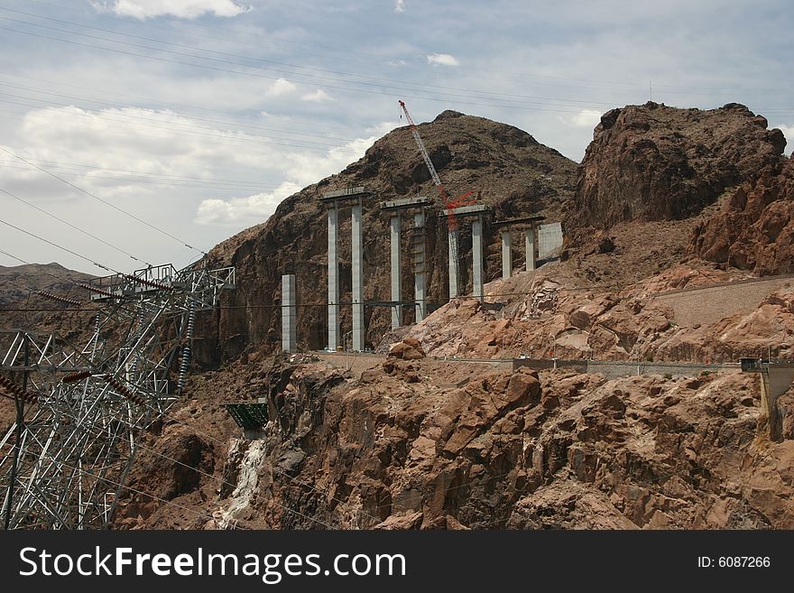 A highway bridge under construction over a deep gorge near Hoover Dam