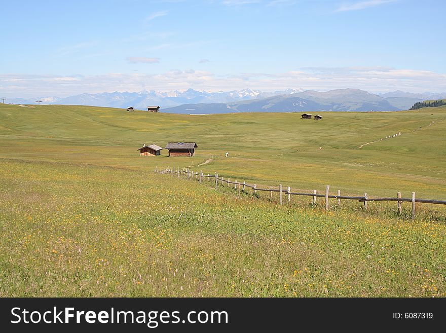 Mountain panorama with cottages and meadows in the front. Mountain panorama with cottages and meadows in the front