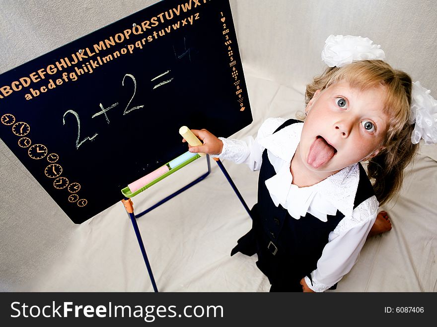 An image of nice little girl near blackboard. An image of nice little girl near blackboard.