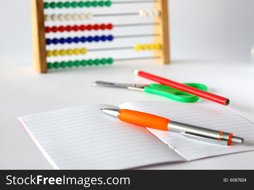 Pen, pencil, scissors, notebook and abacus for  young student. Pen, pencil, scissors, notebook and abacus for  young student