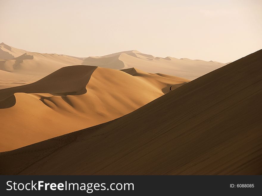 People climbing sand dunes in huacachina peru. People climbing sand dunes in huacachina peru