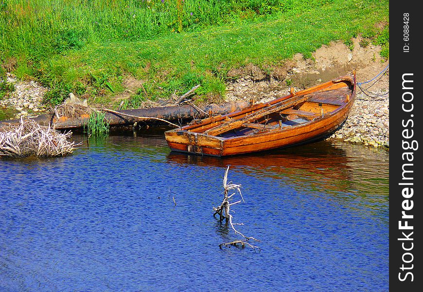 A fishing boat by the riverbank