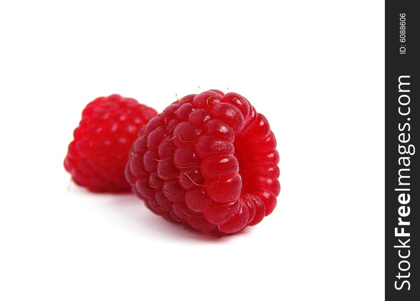 Two raspberriees isolated on white background