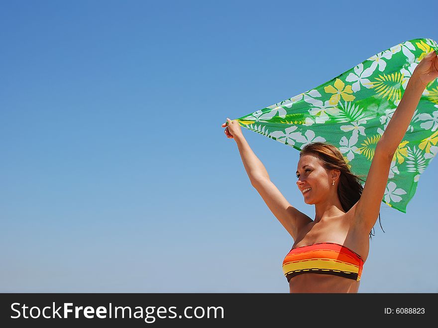 Young beautiful woman has a rest on coast of ocean. Young beautiful woman has a rest on coast of ocean