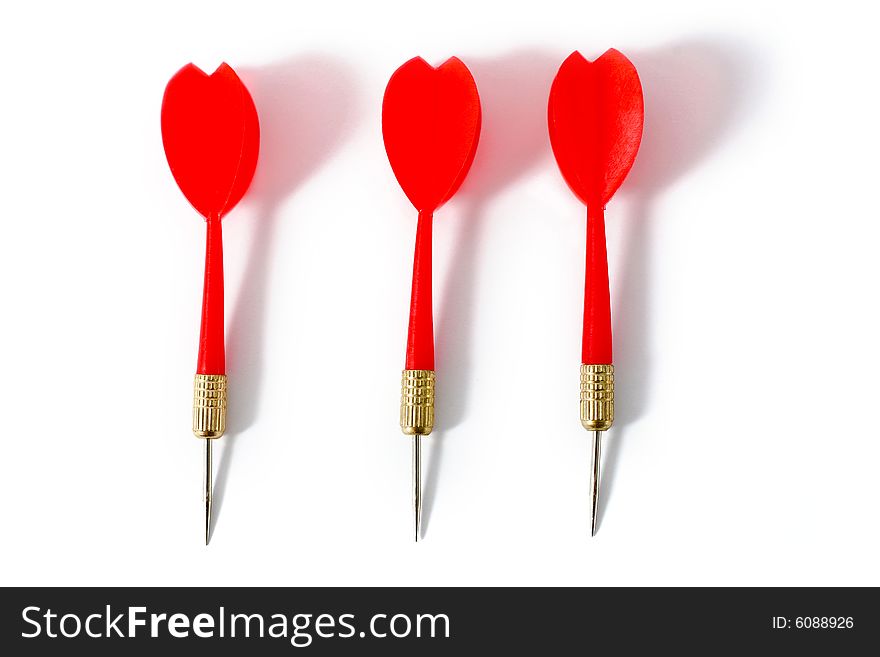 Three red darts close-up on a white surface