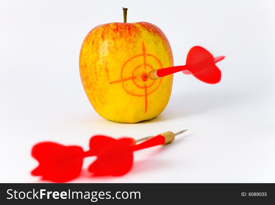 Red-yellow Apple with Dart on White Background