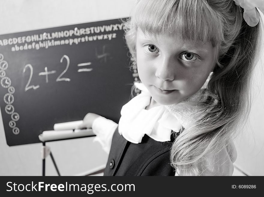Black and white image of little girl near a boards. Black and white image of little girl near a boards