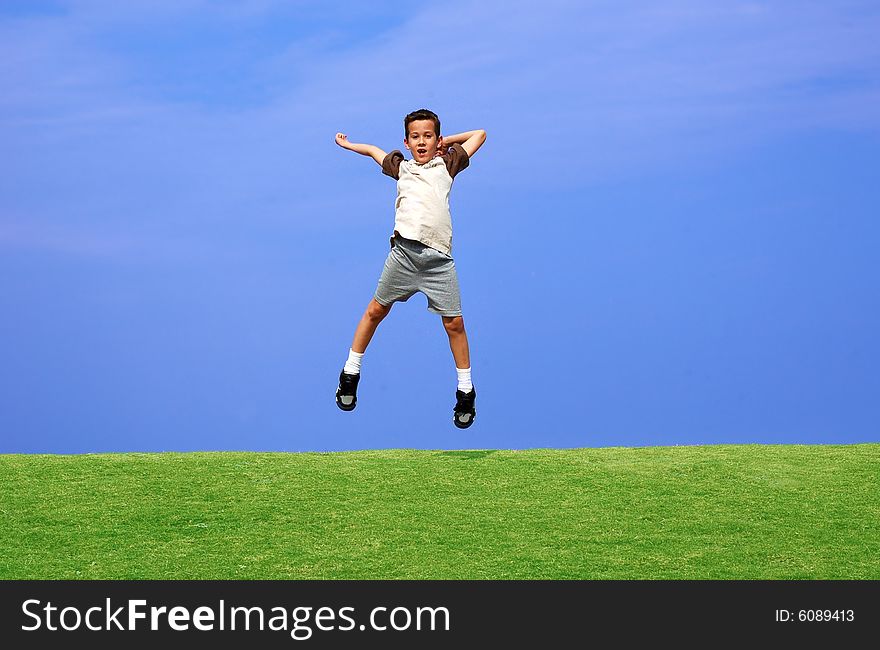 Boy jumping for joy on a clear day