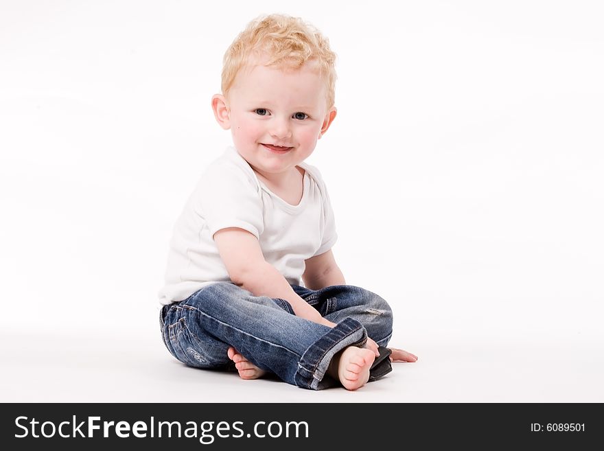 Cute Caucasian blond toddler is happy and playful. Cute Caucasian blond toddler is happy and playful