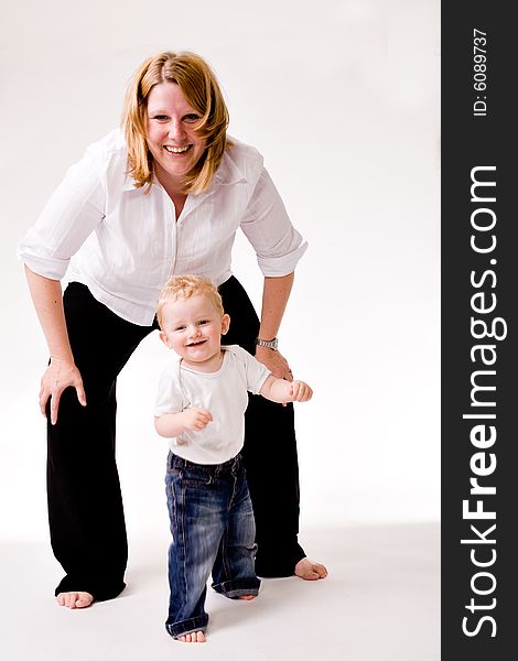 Cute Caucasian blond toddler is happy with his mother. Cute Caucasian blond toddler is happy with his mother