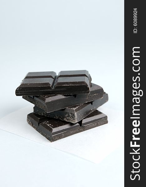 Dark chocolate isolated against a blue background