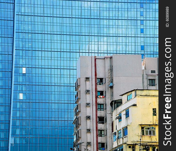 The old and worn buildings standing against the modern building. The old and worn buildings standing against the modern building.