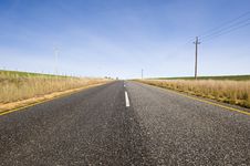 Deserted Country-road Running Through Green Fields Royalty Free Stock Photo Deserted Country-road Running Through Green Fields Royalty Free Stock Photo
