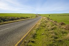 Deserted Country-road Running Through Green Fields Royalty Free Stock Photography Deserted Country-road Running Through Green Fields Royalty Free Stock Photography