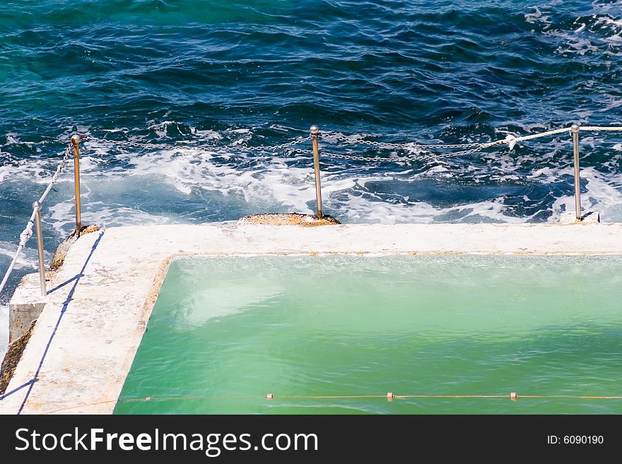 A salt water pool near the ocean. A salt water pool near the ocean