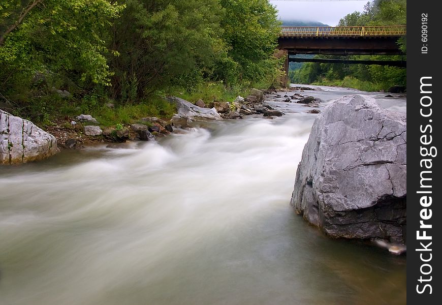 The old bridge through the river in Russia