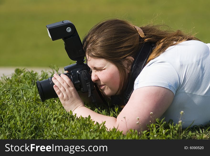 Woman-photographer with camer aiming at someting