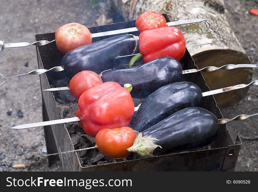 Eggplants and red bell peppers on grill