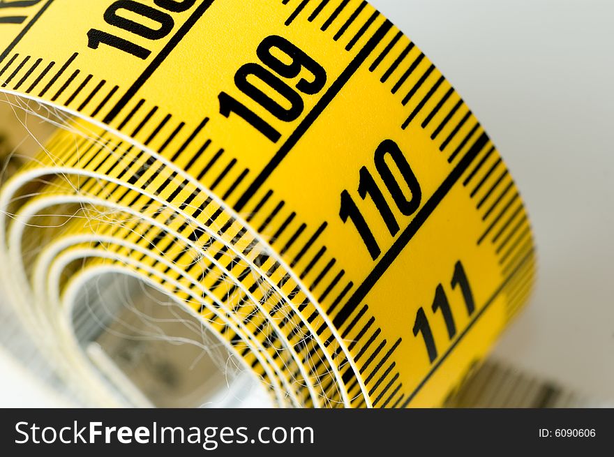 Measuring tape details over a white background