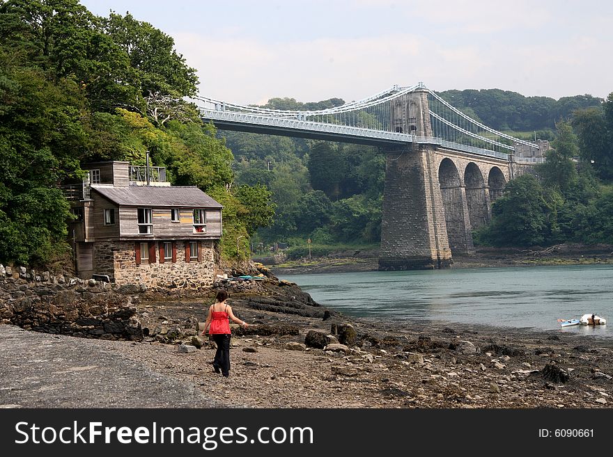 The Menai Suspension Bridge, or Pont Grog y Borth in Welsh, is a suspension bridge between the island of Anglesey and the mainland of Wales.