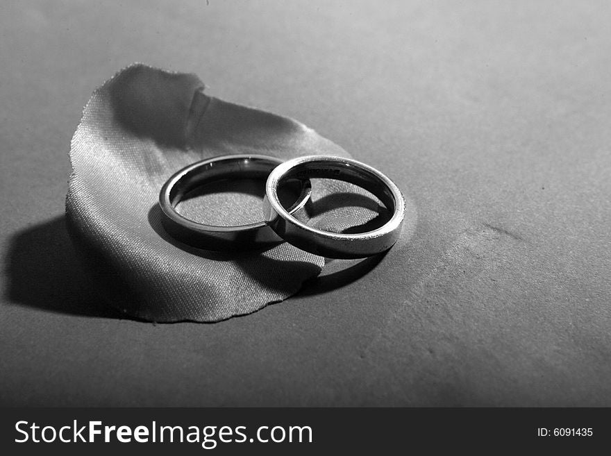 Two wedding rings on a petal