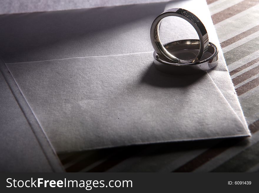 Two wedding rings on an envelope